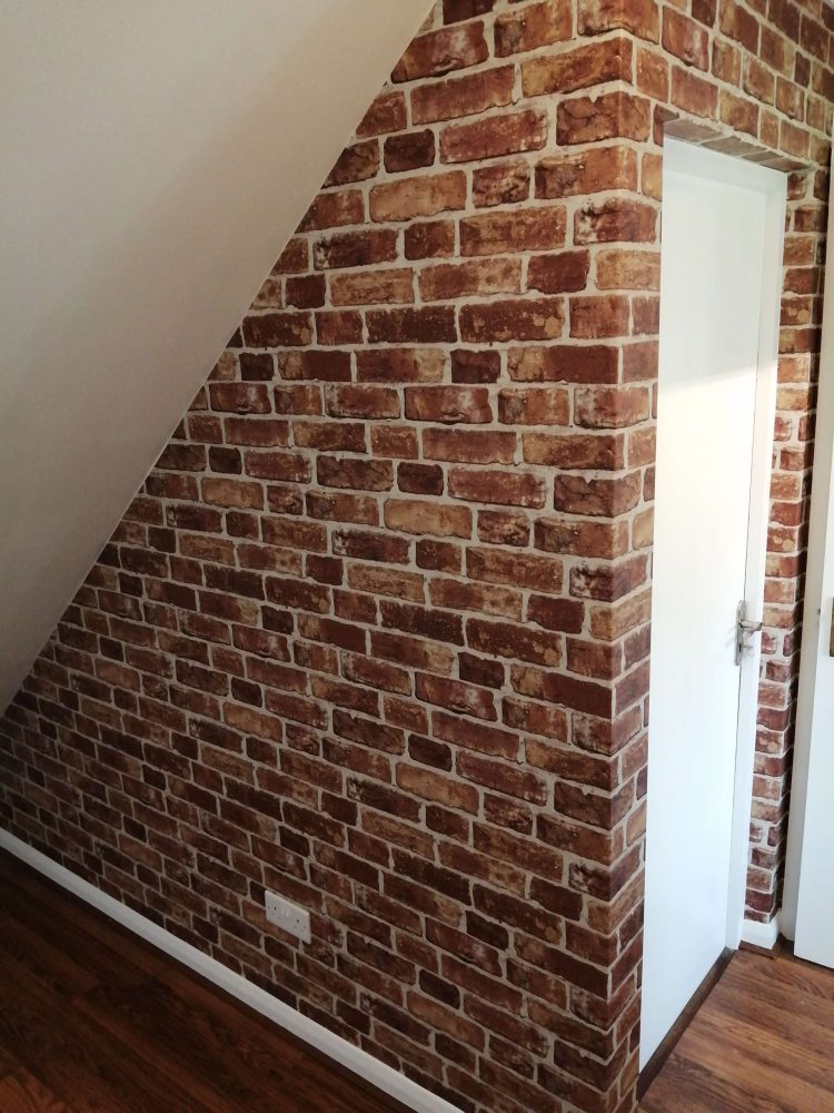 Brick feature wall under stairs